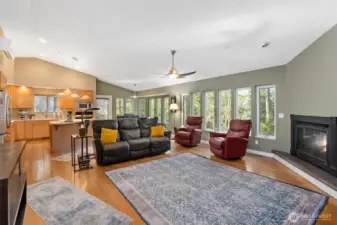 The main residence is anchored by a breathtaking great room with soaring vaulted ceilings, a gas fireplace, & walls of windows overlooking serene Peters Creek.