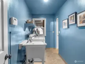 Large laundry room with a man door to the carport.