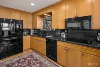 Spacious kitchen with granite counter-tops.