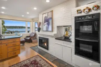 Kitchen view toward lake with fireplace.