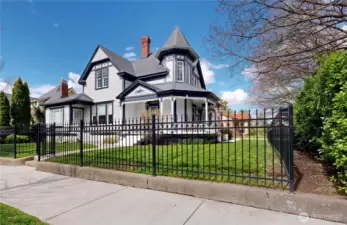 corner view with new wrought iron fence