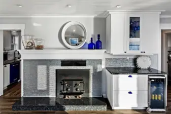 A closer look at the heart of 7316 Eastside Drive NE. The Beach House blends warmth and elegance with custom cabinetry, artisanal tilework, and a wood-burning fireplace—ideal for storm-watching or quiet evenings by the Sound. Thoughtful design meets timeless craftsmanship in every corner.