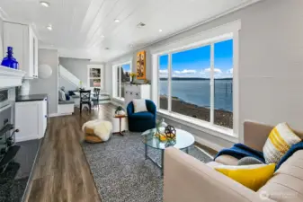A front-row seat to sunset at 7316 Eastside Drive NE. This built-in banquette dining area offers cozy gathering space with wide-open views across Caledonia Cove. Whether it’s morning coffee or a candlelit dinner, the water is always on the menu.
