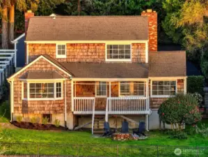 The Cape Cod-style residence at 7314 Eastside Drive NE commands the hillside. This well-preserved 4BD/1.5BA home crowns the estate with sweeping water views, terraced grounds, and a west-facing covered deck—perfect for catching sunset over the Sound. Part of the Caledonia Cove compound, 7314 offers space, privacy, and endless potential.