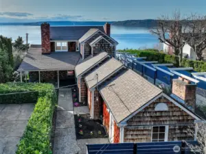From Puget Sound to treetops, the full Caledonia Cove estate unfolds. At water’s edge, the Beach House and Boat House of 7316 Eastside Drive NE welcome the tides. Mid-slope, the Coach House offers utility and versatility. Above it all, the Cape Cod residence at 7314 crowns the hillside with commanding views. Together, the two addresses span a private, multi-tiered retreat from street to shore.