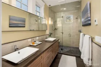 Primary suite en suite bathroom with double vanity and steam shower