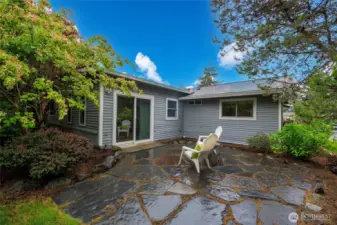 Beautifully landscaped backyard with patio and storage shed.