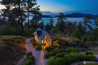 Garden House (~240), inspired by the “Enchanted Garden House” in the June 1998 issue of Better Homes and Gardens, features a steep slate roof and Gothic details using rough-sawn cedar beams and posts, complementing the air loom roses.