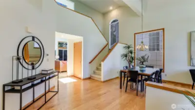As you enter the home this gorgeous view greets you with  beautifully designed entry with soaring ceilings and engineered hardwood floors.