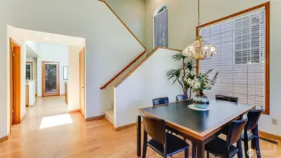 The view shows the hall heading to the family room and the kitchen,  .