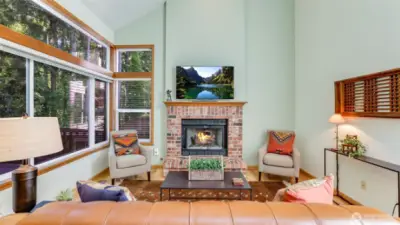 The family room has a tall vaulted ceiling plus a gas log fireplace.