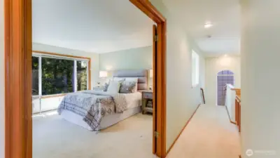 Looking into the primary suite through the wide open double doors.