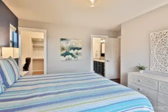 Primary Ensuite...featuring beautifully updated 3/4 bath. To the left is the updated walk in closet with work space created for tucked in office!