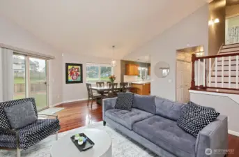 Coming back down the stairs enjoy light and bright family room, spacious area enhanced with Vaulted Ceilings...slider to outside, fully fenced backyard to the left. Now let's head towards the laundry room...which is down the hallway behind the stairs (same hallway that leads to primary suite).