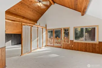 Master suite with walls of windows and big custom river view deck