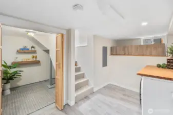 Wine closet or additional storage for downstairs primary.