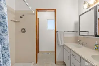 Bathroom on the main-floor. Accessed from the hallway and the primary bedroom.