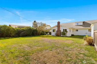 Looking to the house from the back corner of the yard, where there is an additional parking spot off the alley!