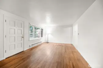 Alternate living room view with a large picture window filling the space with natural light.