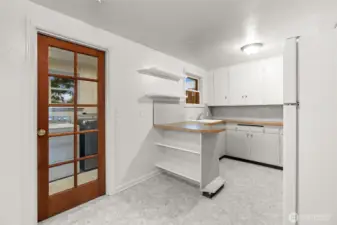 Bright kitchen featuring plenty of cabinetry for storage and ample workspace.