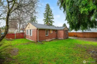 Roomy backyard with open green space ready for play, pets, or outdoor gatherings.
