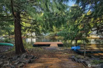 Private dock access from a natural, wooded shoreline, offering a peaceful spot to enjoy the water.