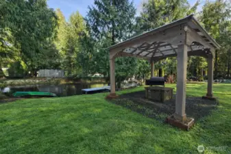 Charming gazebo area overlooking the water, perfect for relaxing or entertaining in a serene outdoor setting.