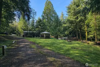 Large, park-like setting with open lawn, mature trees, and ample space for recreation or gatherings.
