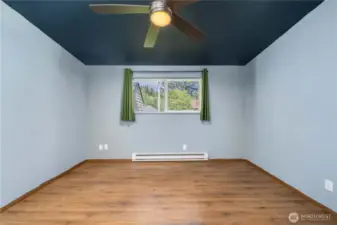Bedroom features updated flooring, baseboard heat, and a large window that brings in plenty of natural light. Ideal as a guest room, home office, or creative space to suit your lifestyle.