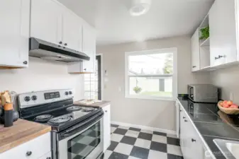 New upper and lower cabinets on the left, with new butcher block countertops.