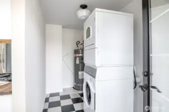 This utility area holds a stackable washer and dryer with room to add storage.