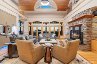 A delightful living room with stone fireplace and massive high vaulted ceilings