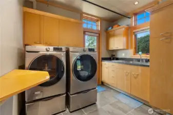 Spacious laundry room with built-in cabinetry