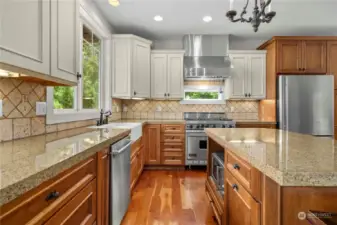 Gorgeous gourmet kitchen boasts of granite countertops complemented by a custom tile backsplash.