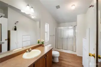 Oversized primary bathroom has space for all your needs.