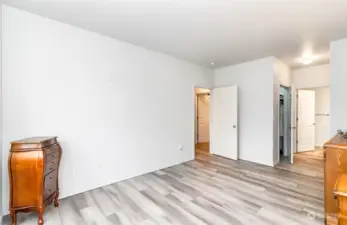 Primary bedroom with walk-in closet, standard closet, and ensuite bathroom