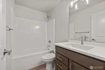 The upstairs bath has a tub/shower combo and a spacious counter.