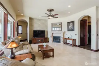 The family room is located near the kitchen and breakfast nook. There is a cozy gas fireplace with custom mantle