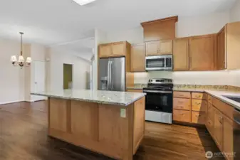 Updated kitchen with quartz, center island eating bar and stainless appliance package, opens to family room, eating area and dining room