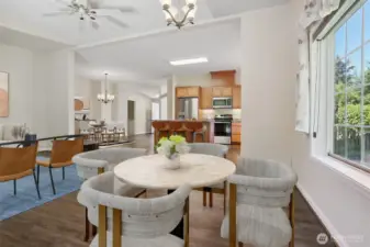 Family room and eating area opens to kitchen.  Sliding door opens to back patio that borders the community greenbelt and trail.  Virtually staged photo.
