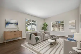 Formal living room with vinyl plank flooring and vaulted ceilings.  Virtually staged photo