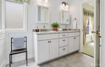 Master bedroom suite with vaulted ceilings, walk in closet and remodeled 5 piece bathroom with a walk in jetted bathtub.   Virtually staged photo.