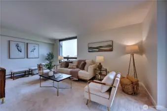 Another look at the gracious living area with large windows allowing natural light & views.