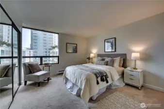King size primary suite & a wall of closet storage leads to lovely double vanity continental style bath.