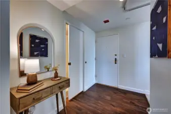 Here is the formal entry to the home, a spacious foyer with beautiful, laminated style wood flooring.