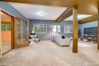 Lower level media room with extra room off to left. Photo from previously staged.