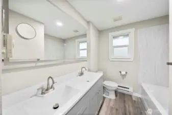 Full size hall bathroom with brand new everything! Matching touch lighting matching mirror, vanity, LVP flooring, paint, lighting, trim and doors.