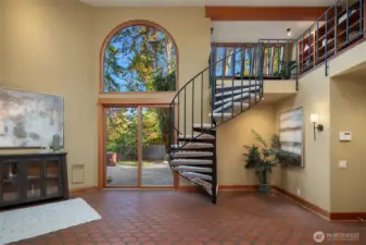 Entry with access to the outdoor patio and spiral staircase up to the loft