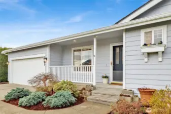 The charming covered front patio is the perfect cozy perch—just right for a rocking chair and your morning coffee or evening unwind.