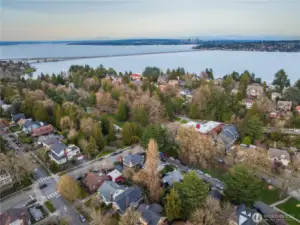 Looking east across the Mount Baker neighborhood toward Lake Washington, with the I-90 floating bridge cutting across the water. Situated directly on Mt. Baker Blvd, the home is moments from the neighborhood's best amenities — including Mioposto, Velvet Elk Cocktail Bar, and Bright Spot Cafe — along with a nearby playground and pickleball courts, all within easy reach of this convenient, community-centered location.